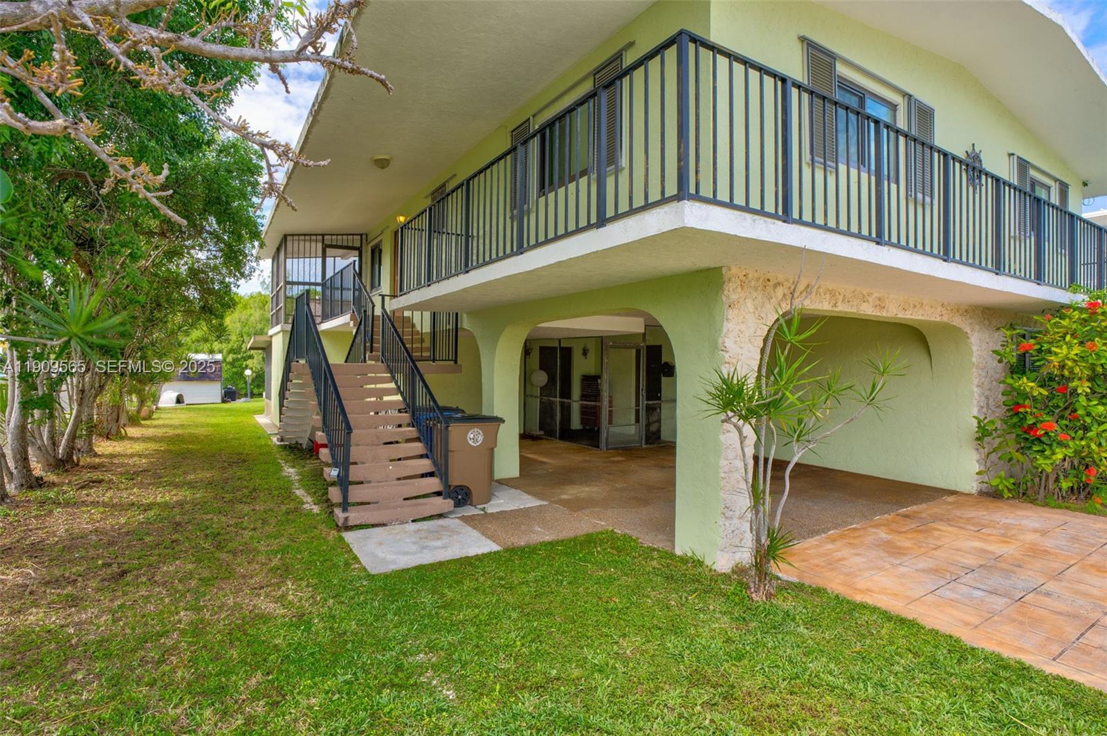 877 Ellen Drive Key Largo, FL 33037 - Photo 35 of 39 a view of a house with a small yard plants and large tree