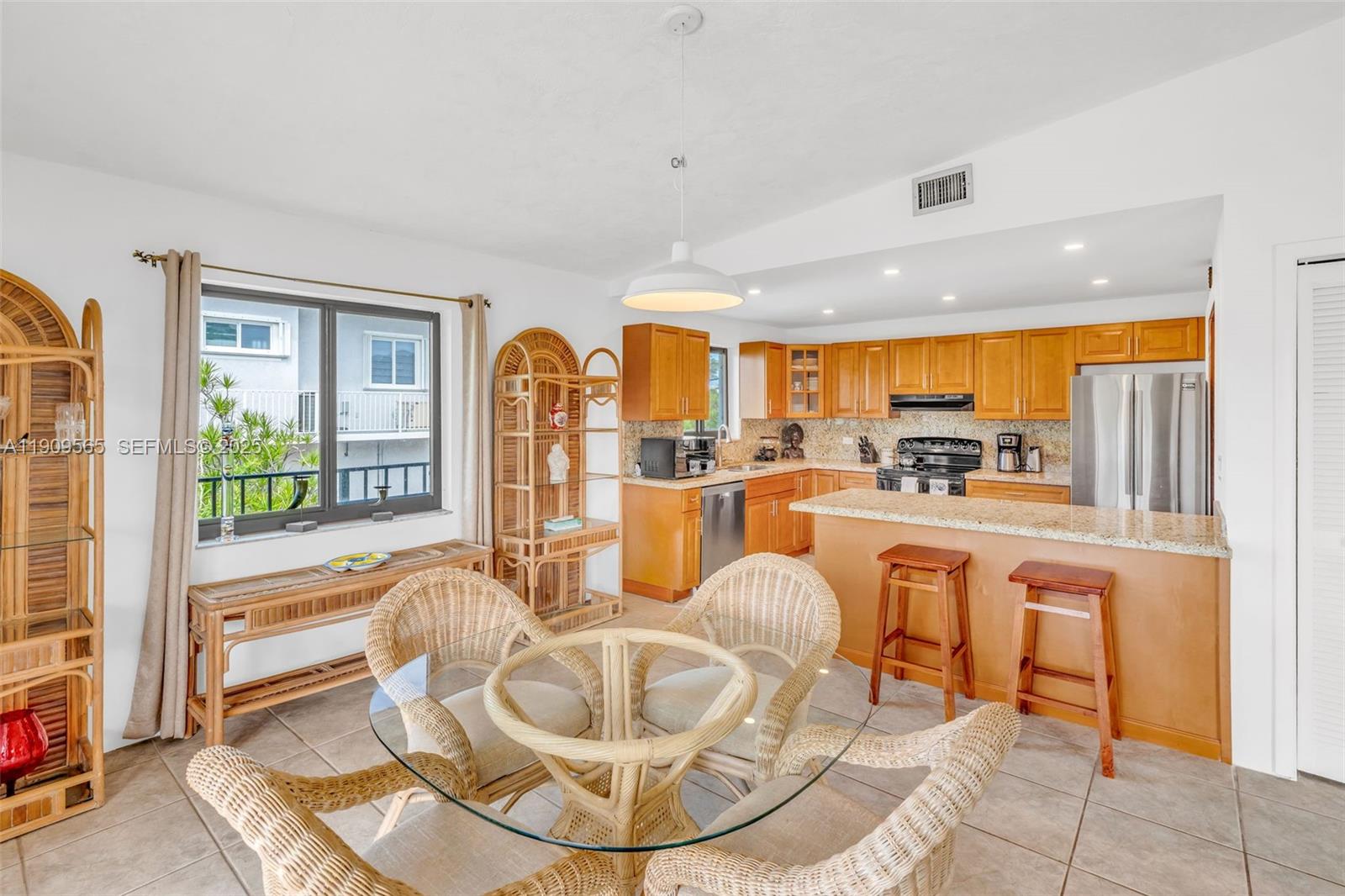 877 Ellen Drive Key Largo, FL 33037 - Photo 5 of 39 a living room with large couches a dining table and chairs with outer view