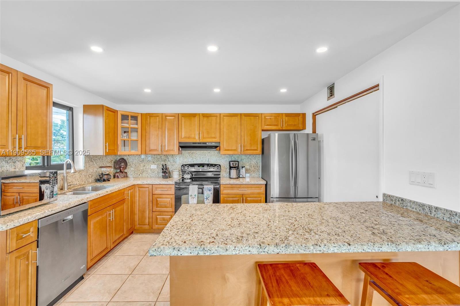 877 Ellen Drive Key Largo, FL 33037 - Photo 8 of 39 a kitchen with stainless steel appliances granite countertop sink stove and refrigerator