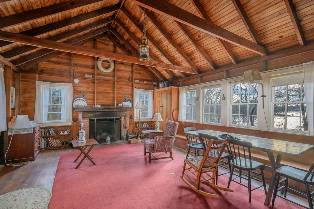141 Nyes Neck Road Barnstable, MA 02632 - Photo 12 of 31 a living room with furniture and a fireplace