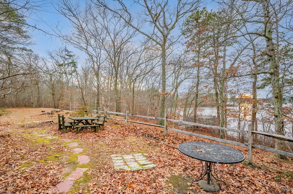 141 Nyes Neck Road Barnstable, MA 02632 - Photo 27 of 31 a backyard of a house with table and chairs