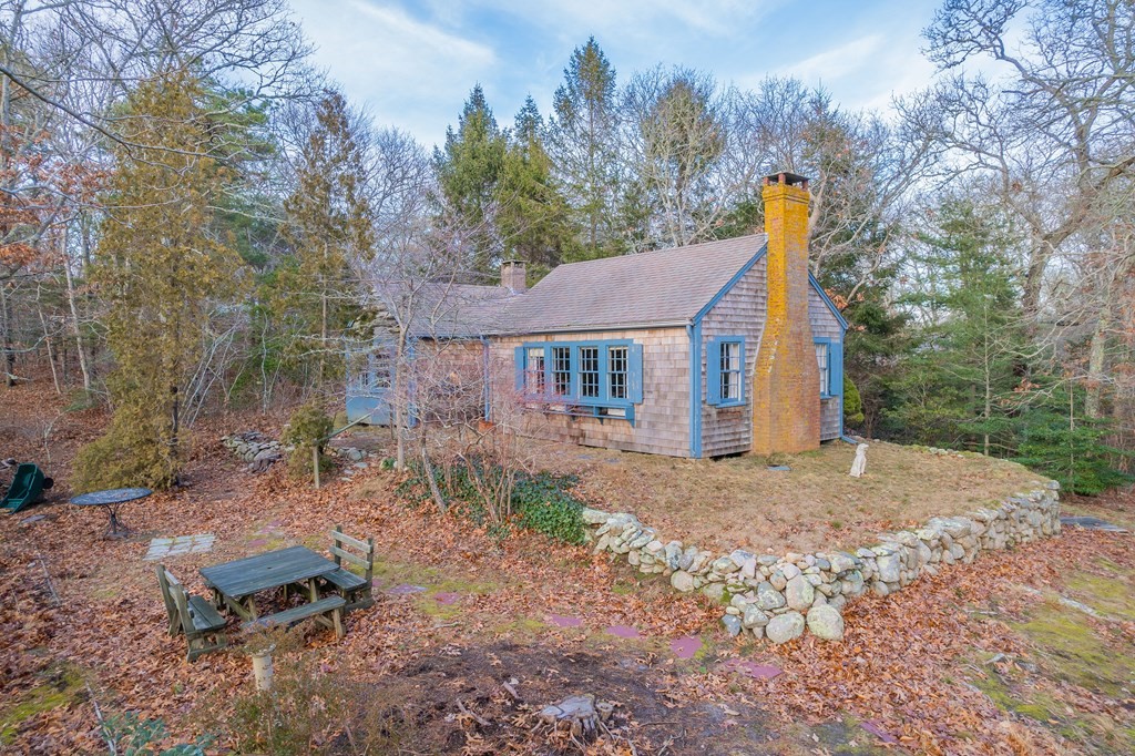 141 Nyes Neck Road Barnstable, MA 02632 - Photo 8 of 31 a view of a house with a yard and sitting area