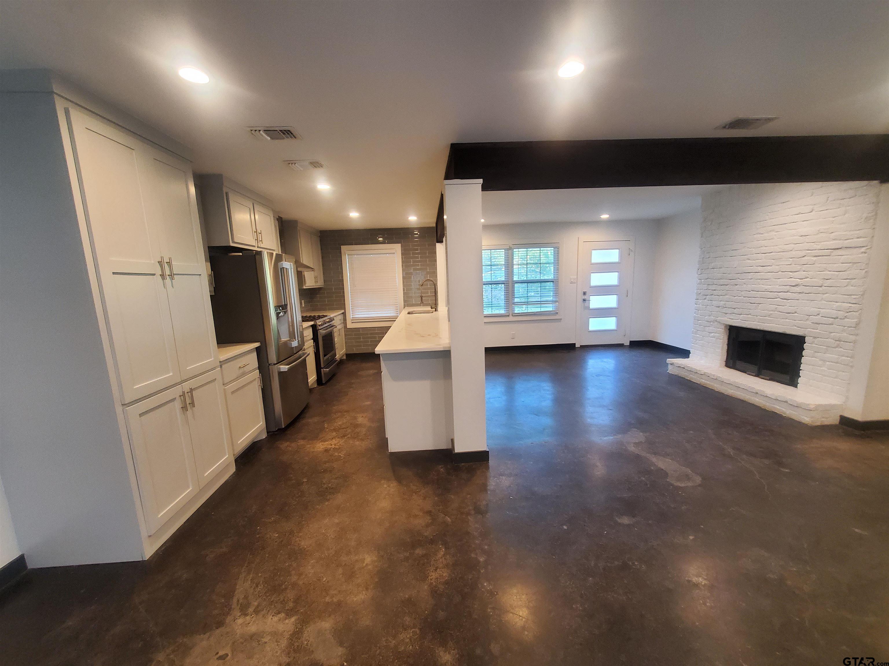 2917 Amy Lane Tyler, TX 75701 - Photo 11 of 36 a view of a living room a fireplace and windows