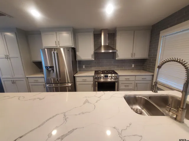 a kitchen with a refrigerator sink and stove