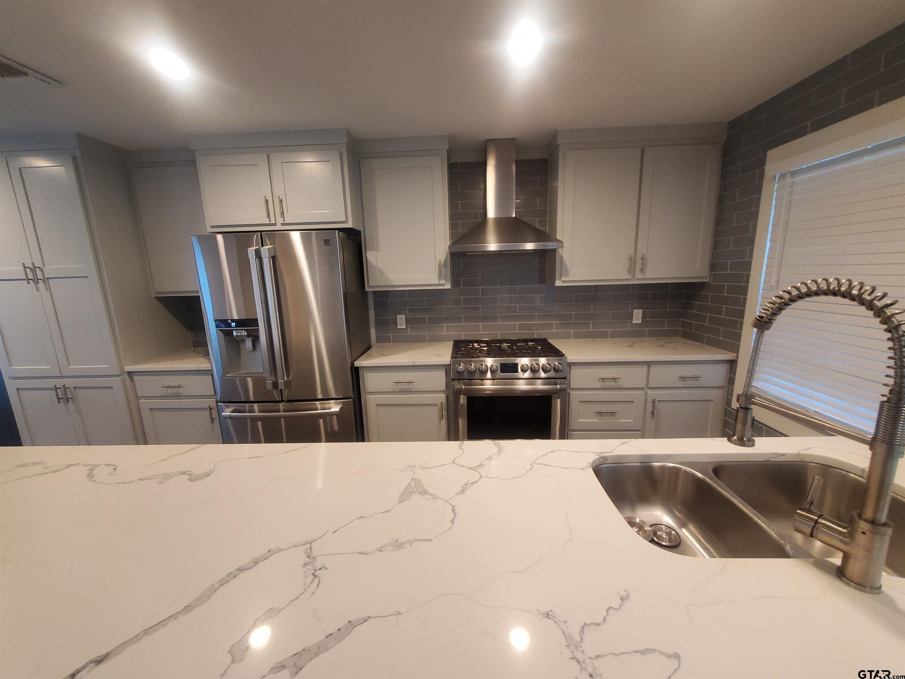 2917 Amy Lane Tyler, TX 75701 - Photo 14 of 36 a kitchen with a refrigerator sink and stove