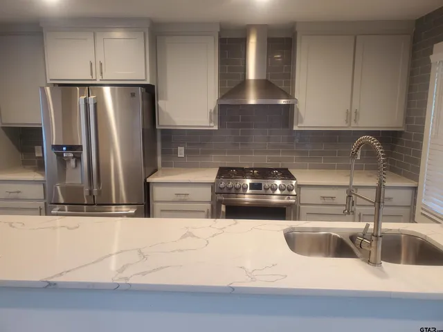 a kitchen with a sink and a refrigerator