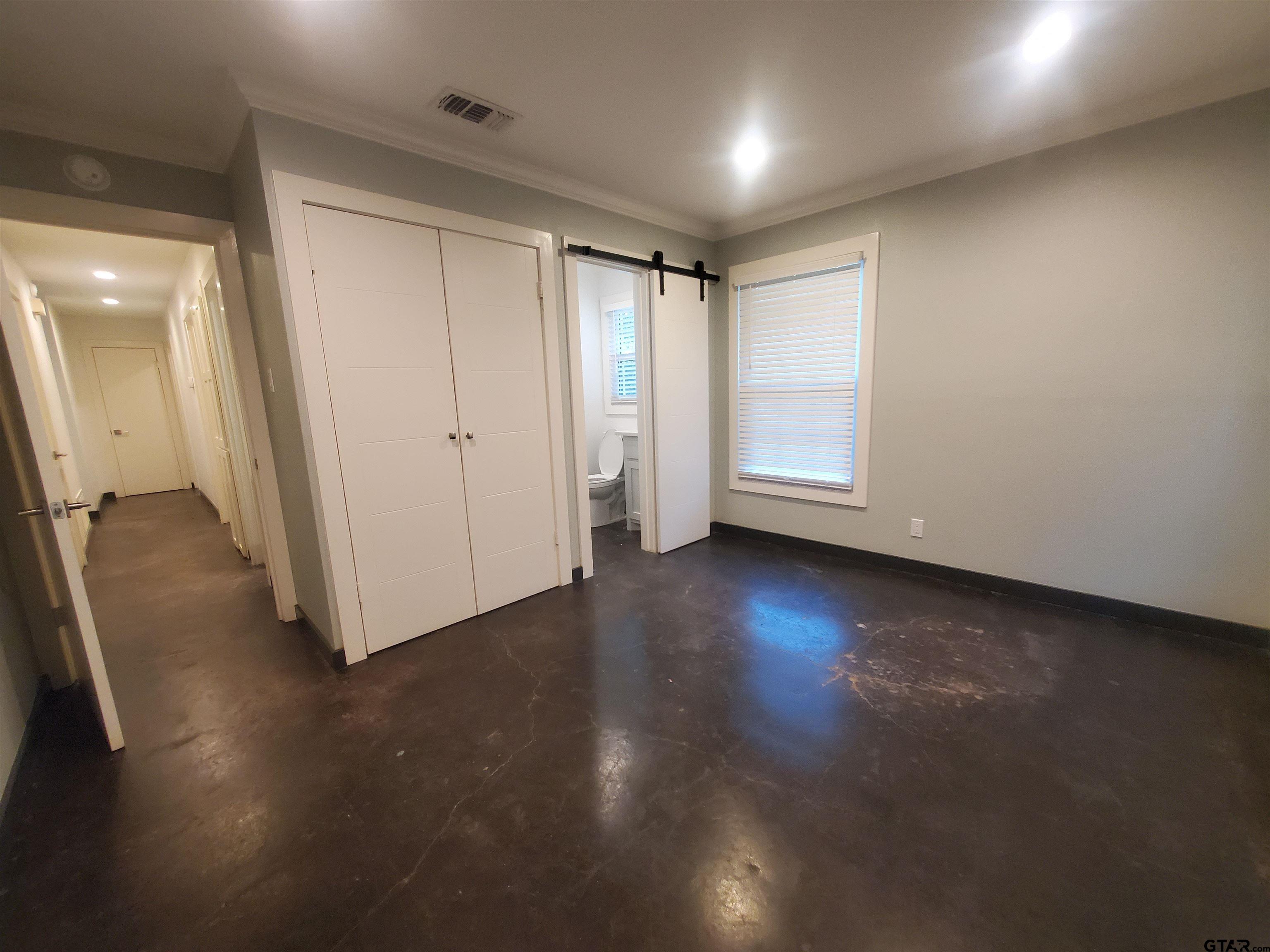 2917 Amy Lane Tyler, TX 75701 - Photo 19 of 36 an empty room with wooden floor and windows