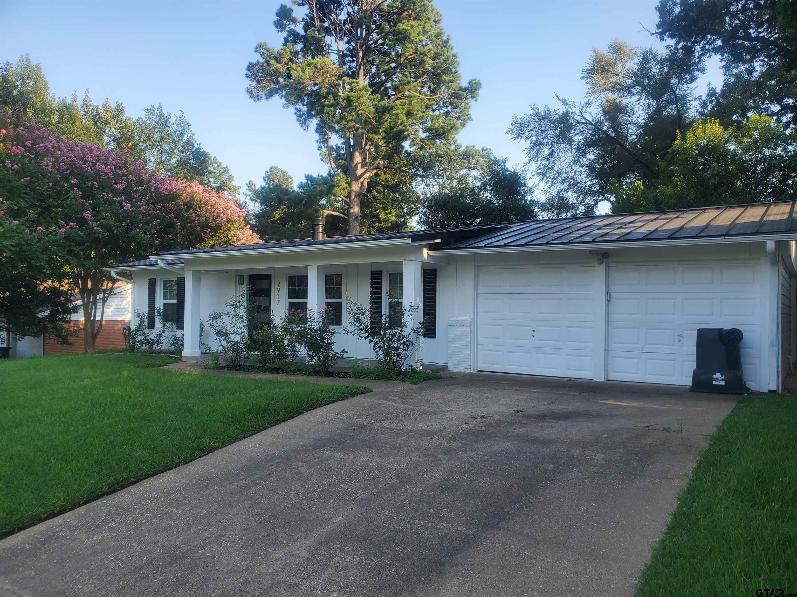 2917 Amy Lane Tyler, TX 75701 - Photo 2 of 36 a front view of a house with a garden and trees