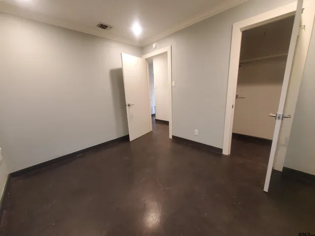 an empty room with wooden floor and a window