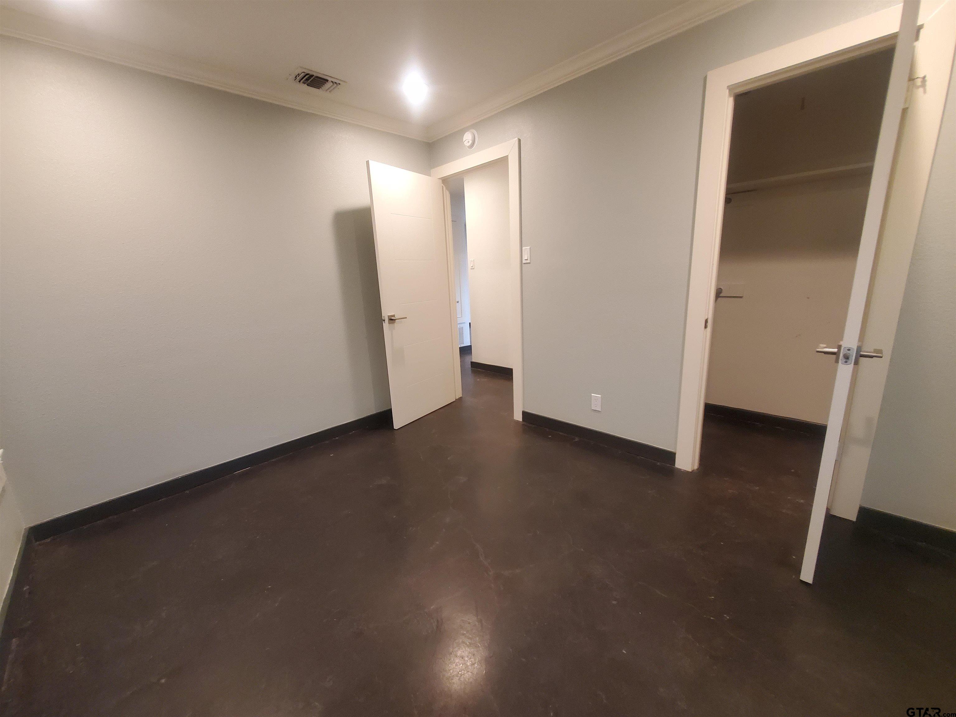 2917 Amy Lane Tyler, TX 75701 - Photo 23 of 36 an empty room with wooden floor and a window