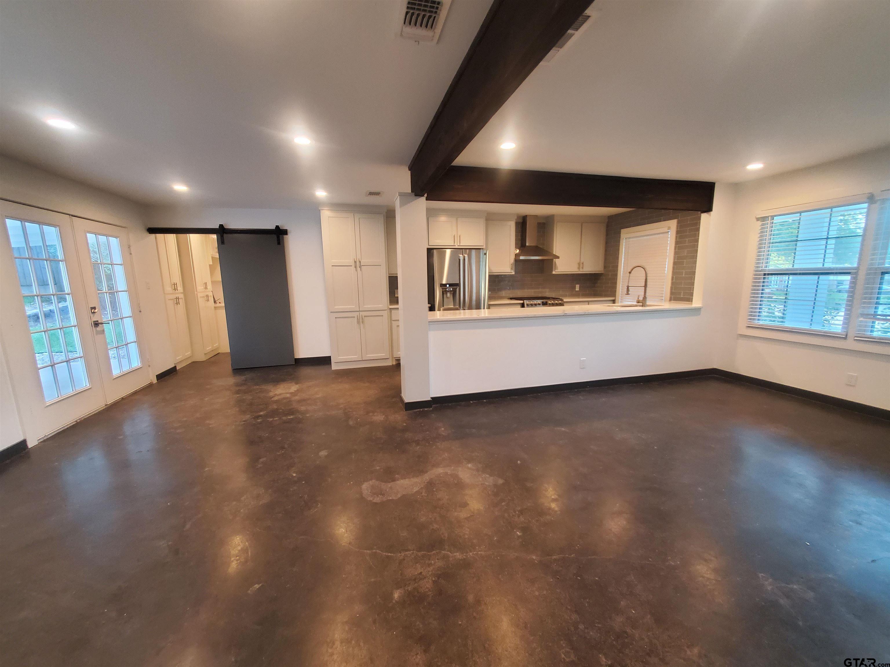 2917 Amy Lane Tyler, TX 75701 - Photo 25 of 36 an empty room with wooden floor and windows