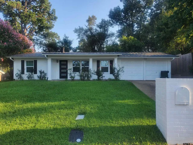 a view of house that has a yard
