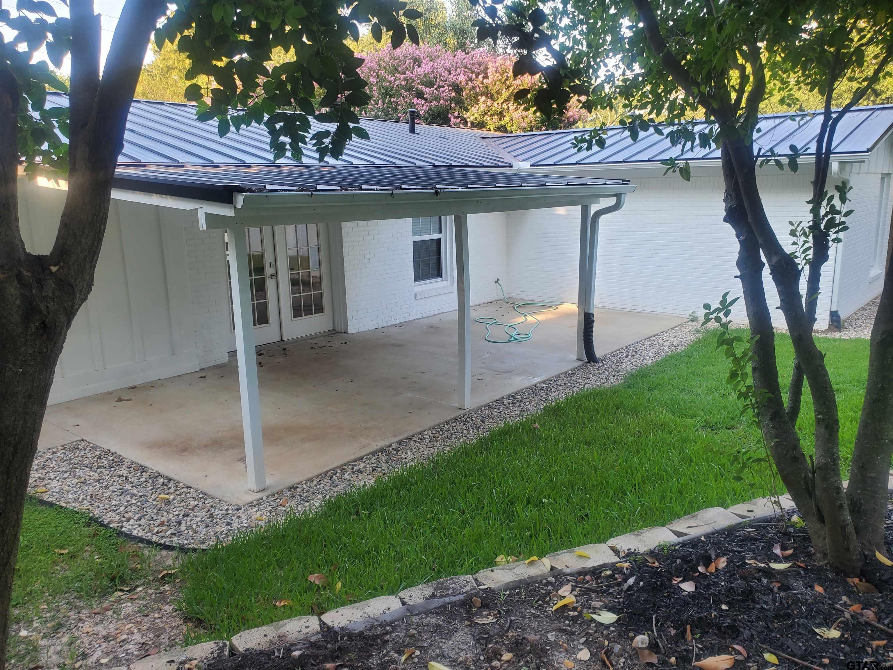 2917 Amy Lane Tyler, TX 75701 - Photo 31 of 36 a view of a backyard with table and chairs plants and a barbeque