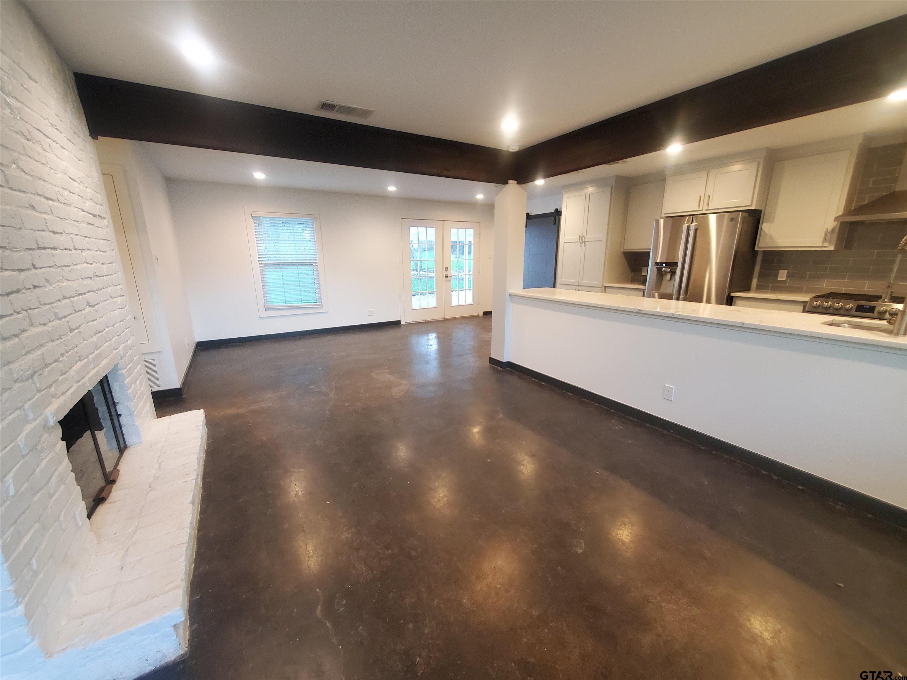 2917 Amy Lane Tyler, TX 75701 - Photo 6 of 36 a large hall with stainless steel appliances wooden floors and view kitchen