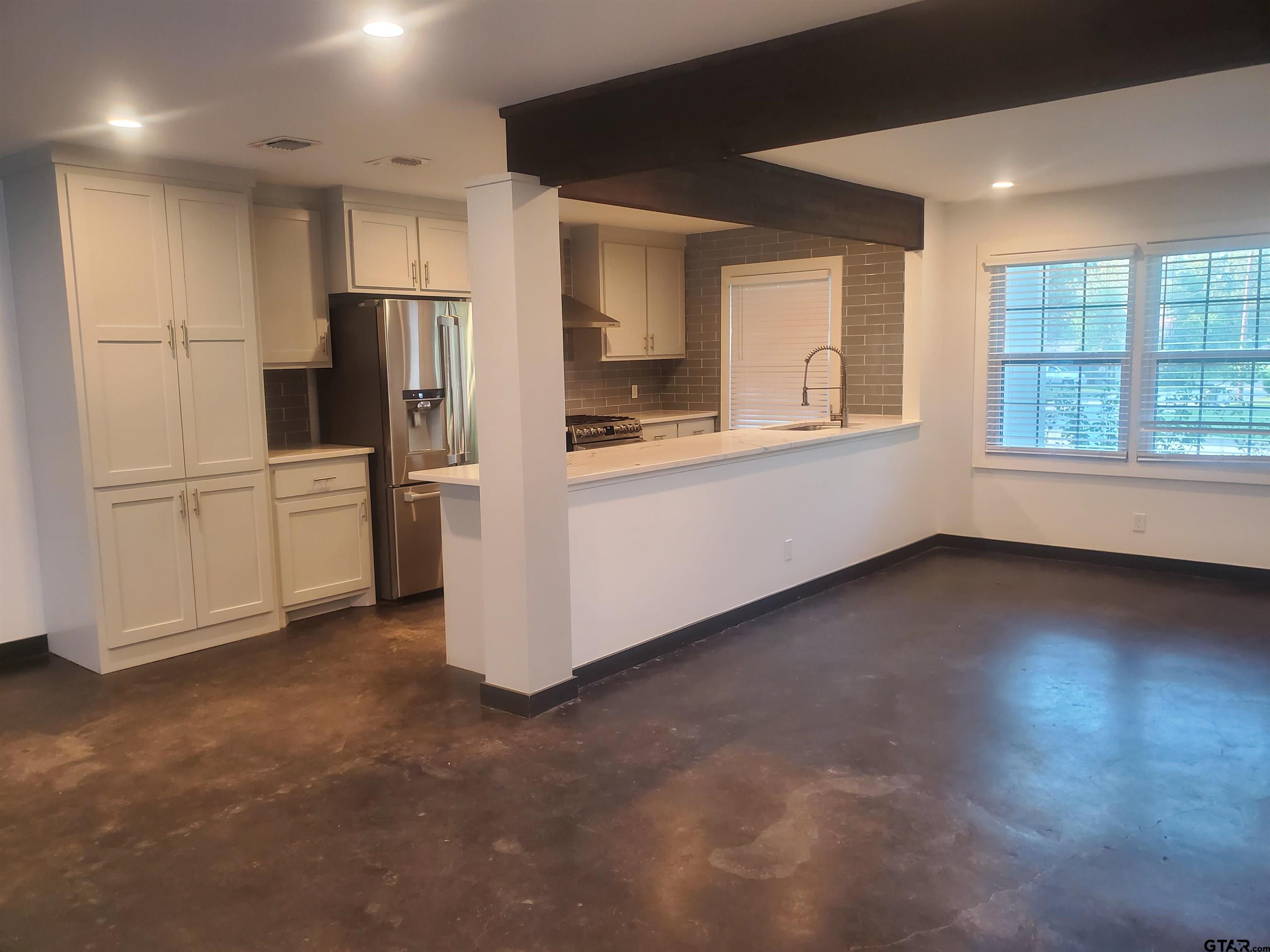 2917 Amy Lane Tyler, TX 75701 - Photo 9 of 36 a view of a kitchen with refrigerator and wooden floor