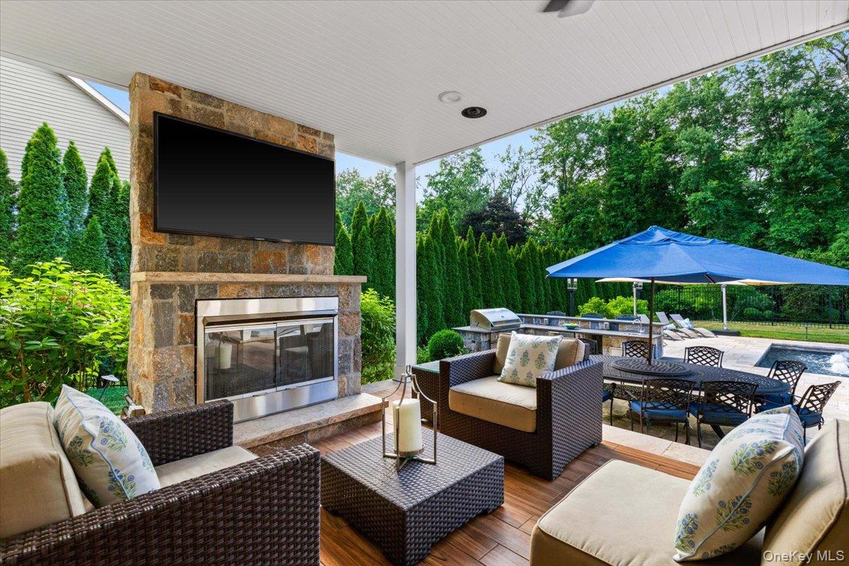 32 Rolling Ridge Road White Plains, NY 10605 - Photo 29 of 32 On chillier days, warm up near the gas fireplace and watch the game on your outdoor TV.