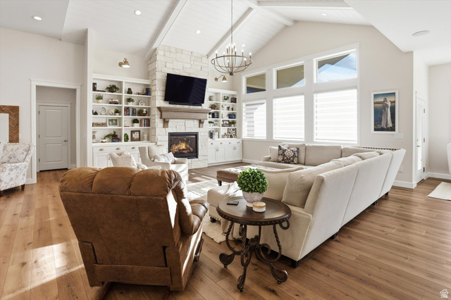 534 East Fish Hatchery Road Mantua, UT 84324 - Photo 8 of 87 Living room featuring hardwood / wood-style floors, a chandelier, and a fireplace