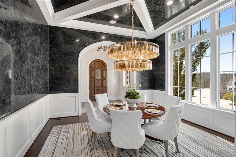 560 Lost River Bend Milton, GA 30004 - Photo 20 of 62 a view of a dining room with furniture wooden floor and chandelier