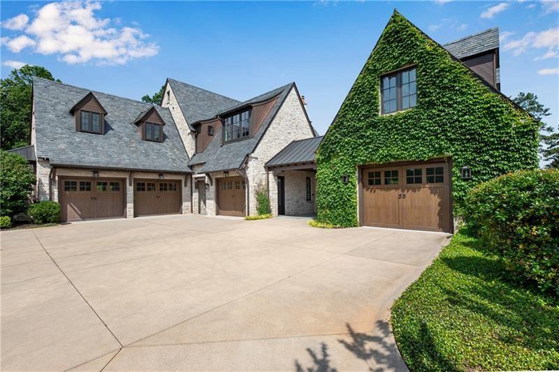 560 Lost River Bend Milton, GA 30004 - Photo 59 of 62 a front view of a house with a garden and trees
