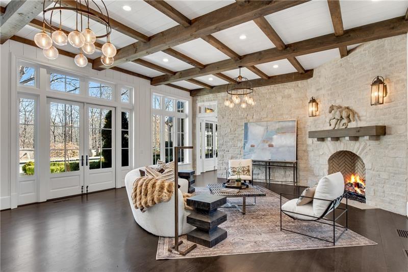 560 Lost River Bend Milton, GA 30004 - Photo 8 of 62 a living room with furniture a fireplace and wooden floor