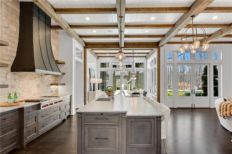 560 Lost River Bend Milton, GA 30004 - Photo 9 of 62 a kitchen with a large window a sink and cabinets