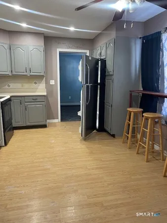a kitchen with stainless steel appliances a refrigerator and cabinets