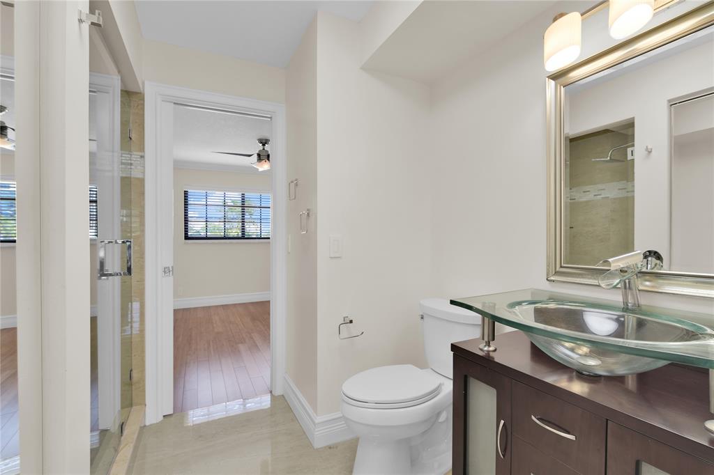 250 East Royal Palm Road, Unit 2A Boca Raton, FL 33432 - Photo 14 of 26 a bathroom with a sink toilet and shower