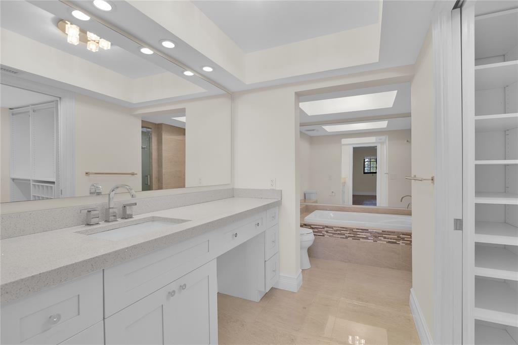 250 East Royal Palm Road, Unit 2A Boca Raton, FL 33432 - Photo 17 of 26 a en suite bathroom with a sink and a mirror