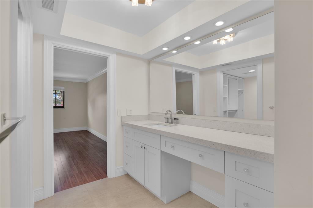 250 East Royal Palm Road, Unit 2A Boca Raton, FL 33432 - Photo 18 of 26 a bathroom with a sink double vanity and a mirror