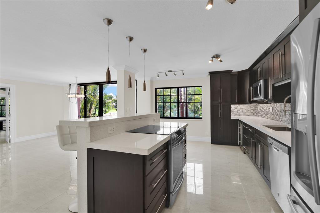 250 East Royal Palm Road, Unit 2A Boca Raton, FL 33432 - Photo 2 of 26 a kitchen with stainless steel appliances granite countertop a sink stove and refrigerator