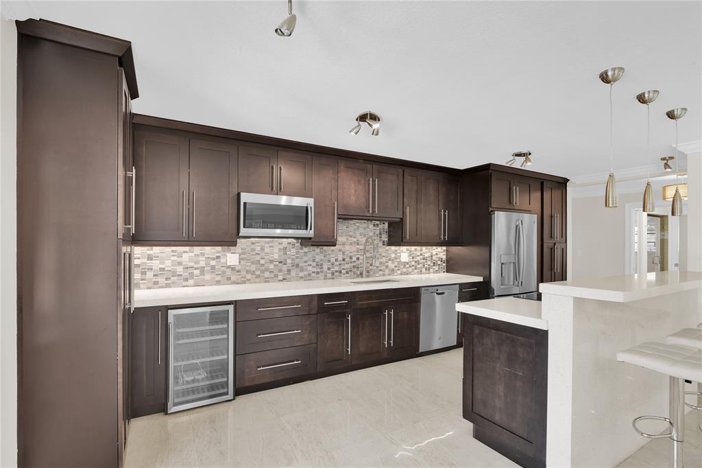 250 East Royal Palm Road, Unit 2A Boca Raton, FL 33432 - Photo 4 of 26 a kitchen with stainless steel appliances granite countertop a stove and a refrigerator
