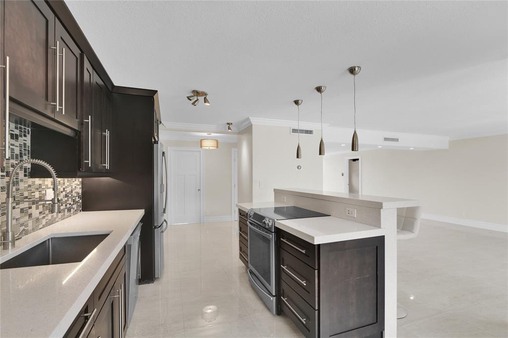 250 East Royal Palm Road, Unit 2A Boca Raton, FL 33432 - Photo 5 of 26 a kitchen with a stove and a refrigerator