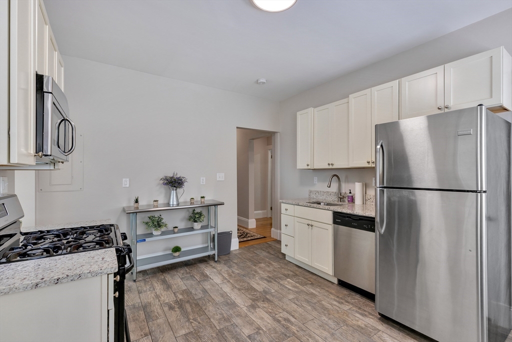 24 Bentley Street, Unit 1 Boston, MA 02135 - Photo 12 of 21 a kitchen with a refrigerator and a stove