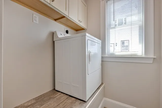 a view of a hallway with closet and wooden floor