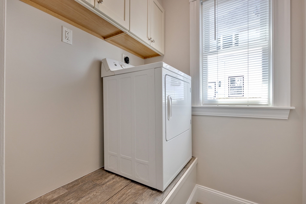 24 Bentley Street, Unit 1 Boston, MA 02135 - Photo 13 of 21 a view of a hallway with closet and wooden floor
