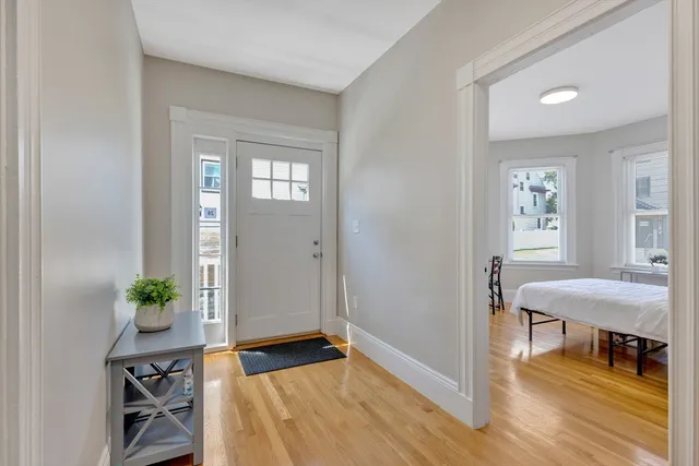 a view of a room that has a bed and a window in it