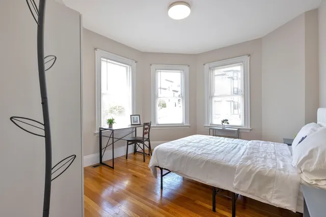 a bedroom with a bed and a table