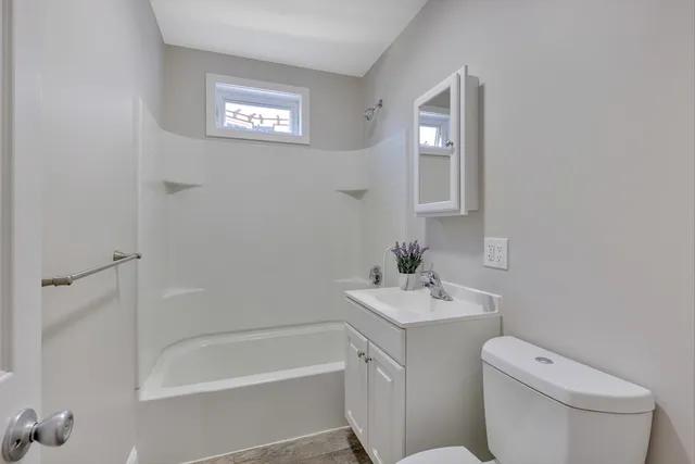 a bathroom with a toilet sink and a bathtub
