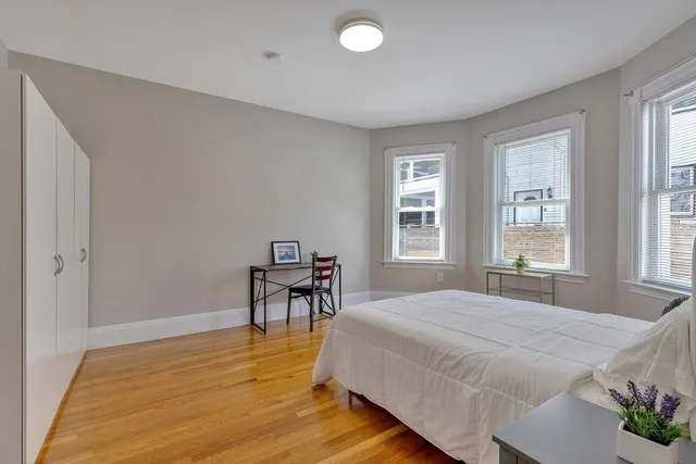 a bedroom with a bed and a table