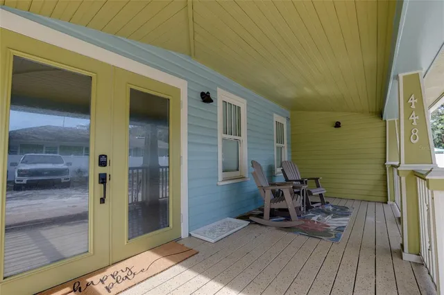 a view of a balcony with furniture and wooden floor