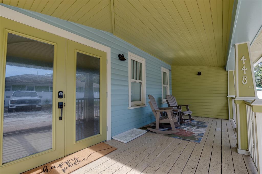 a view of a balcony with furniture and wooden floor