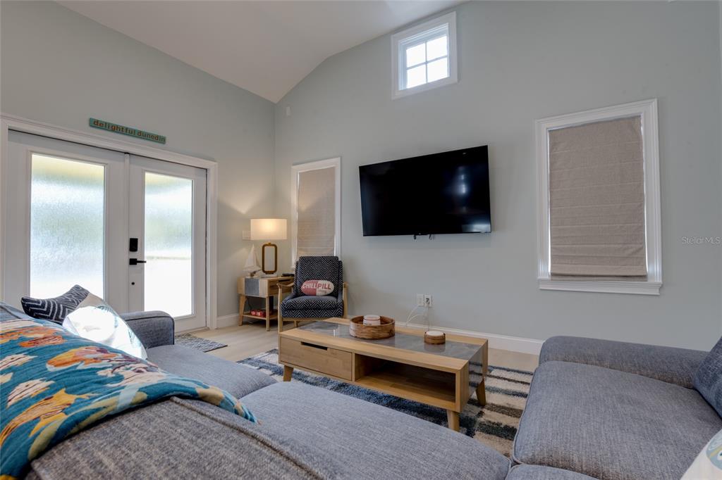 448 Locklie Street Dunedin, FL 34698 - Photo 11 of 51 a bedroom with a bed and a flat screen television
