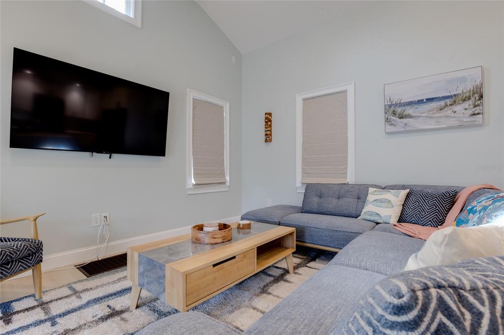 448 Locklie Street Dunedin, FL 34698 - Photo 12 of 51 a living room with furniture and a flat screen tv