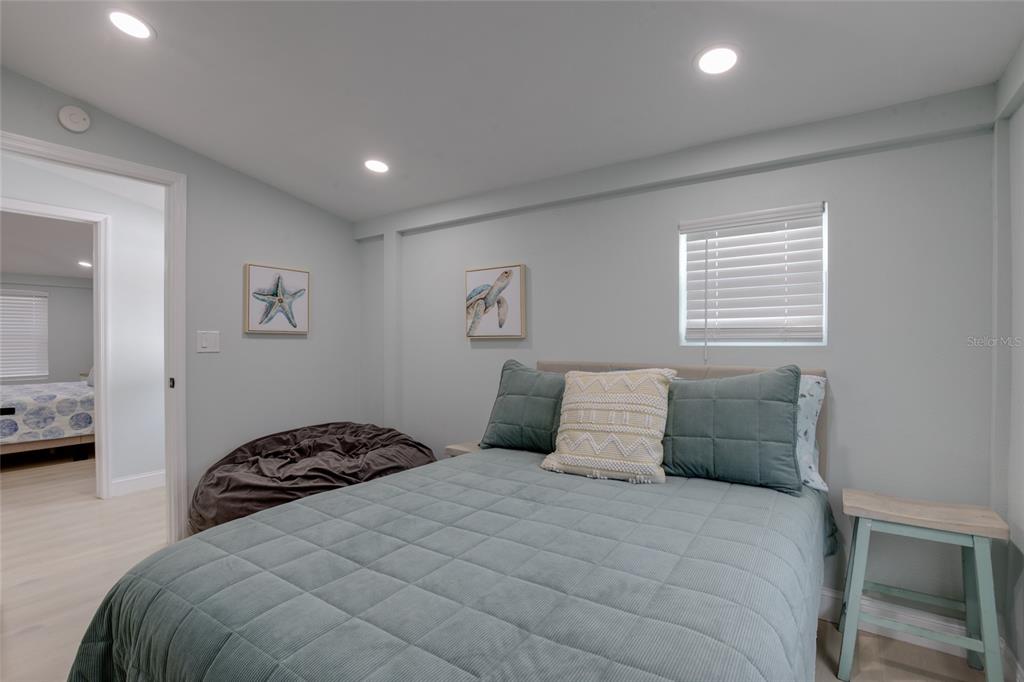 448 Locklie Street Dunedin, FL 34698 - Photo 20 of 51 a bedroom with a bed and a view of bathroom