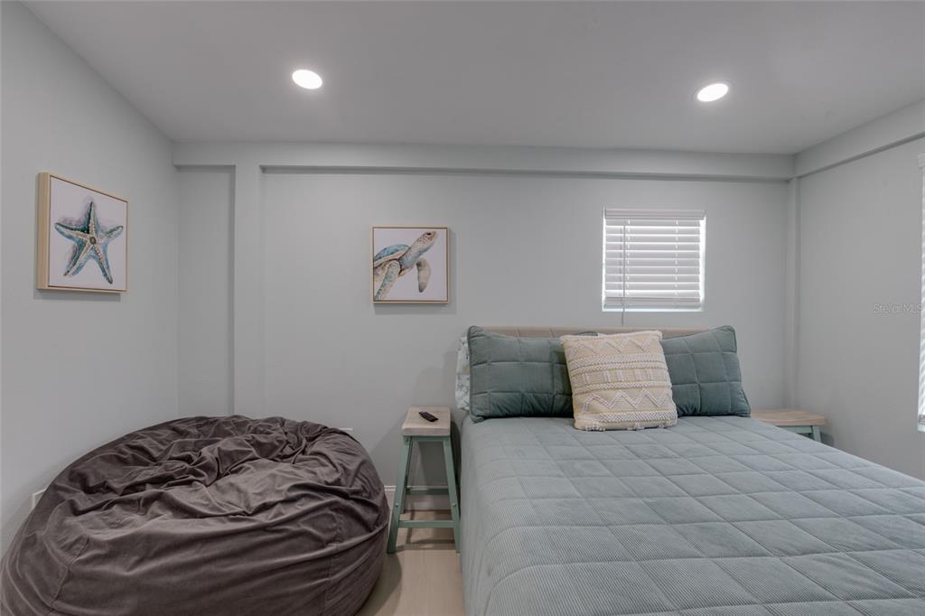 448 Locklie Street Dunedin, FL 34698 - Photo 21 of 51 a bedroom with a bed and a window