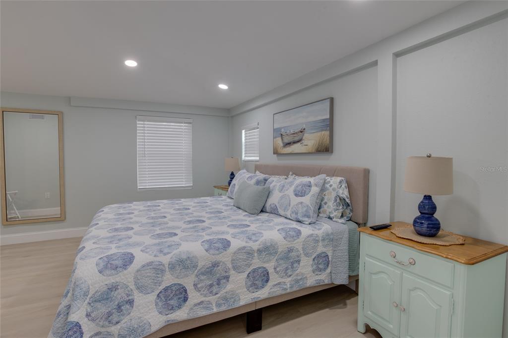 448 Locklie Street Dunedin, FL 34698 - Photo 24 of 51 a bedroom with a large bed and a dresser