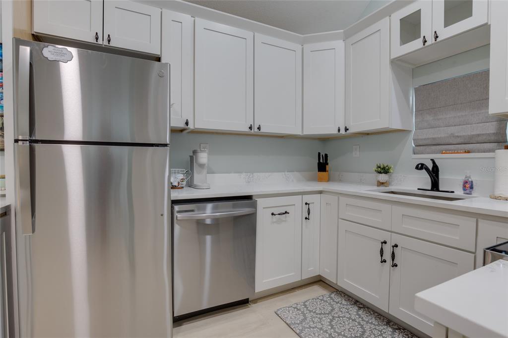 448 Locklie Street Dunedin, FL 34698 - Photo 40 of 51 a kitchen with a refrigerator sink and cabinets