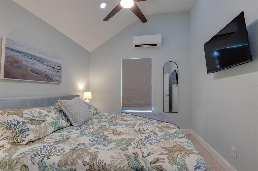 448 Locklie Street Dunedin, FL 34698 - Photo 42 of 51 a bedroom with a bed and a flat screen tv