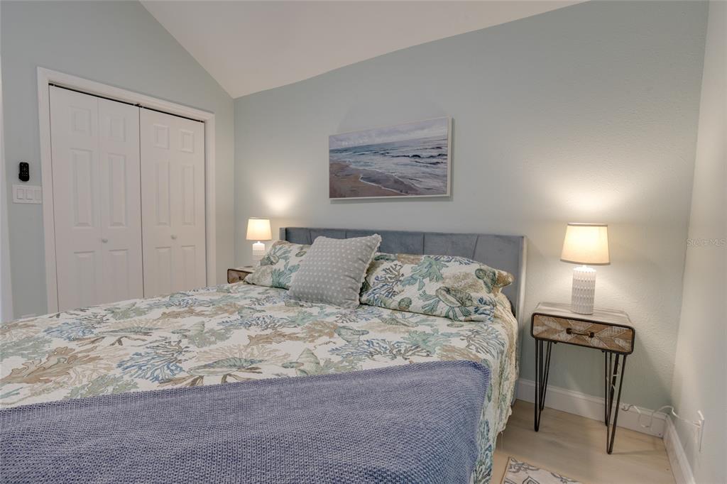 448 Locklie Street Dunedin, FL 34698 - Photo 43 of 51 a large bed sitting in a bedroom and lamp