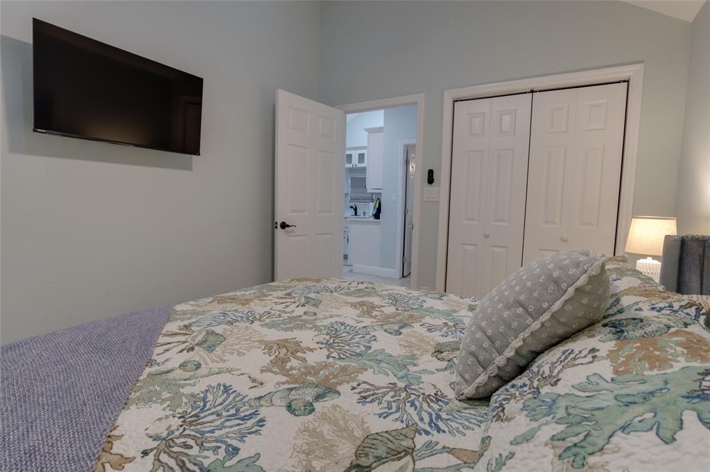 448 Locklie Street Dunedin, FL 34698 - Photo 44 of 51 a bedroom with a bed and a flat screen tv